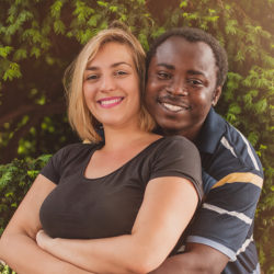 Outdoor portrait of romantic and happy international young couple in park